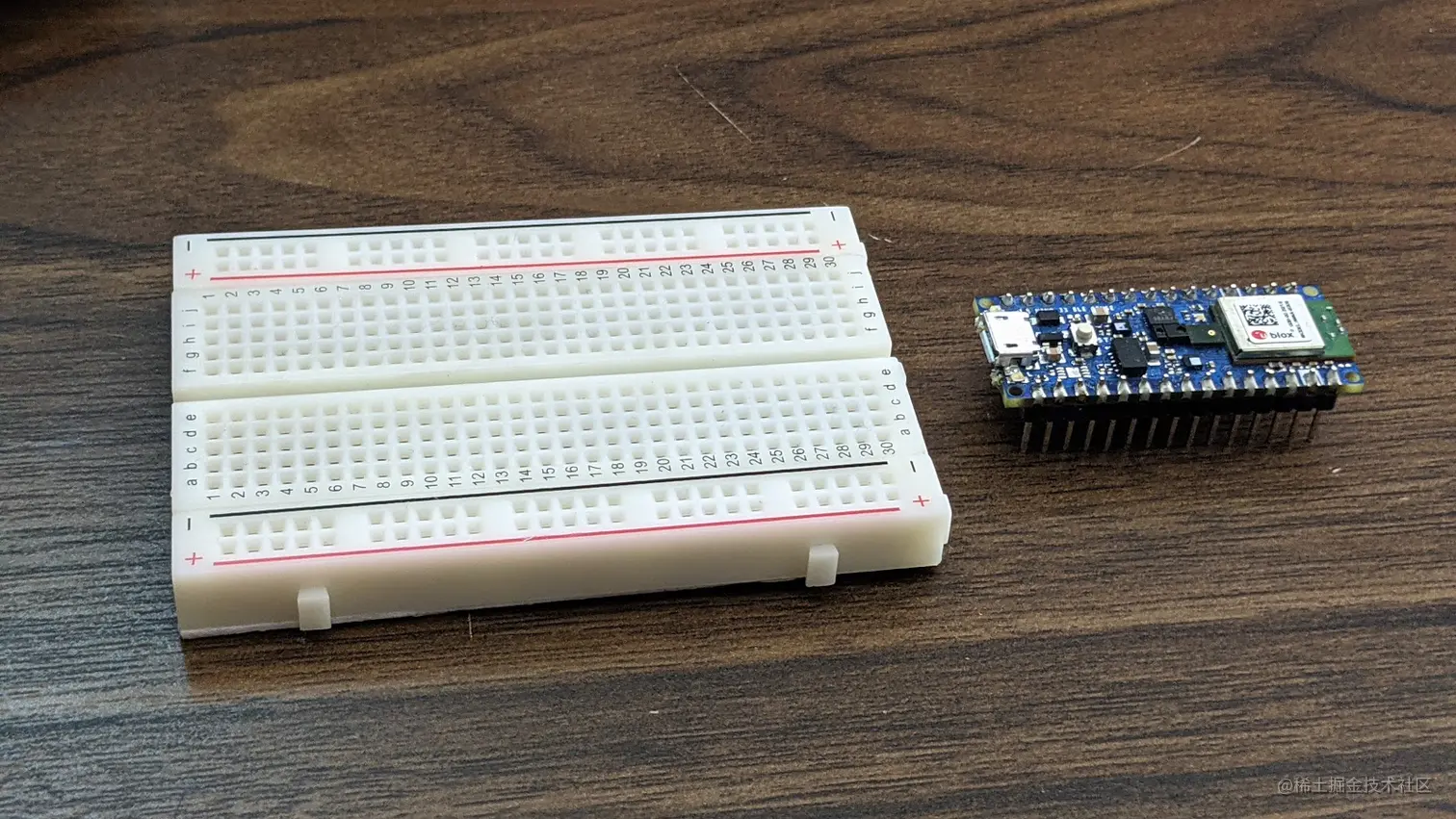 Image of the Arduino Nano 33 BLE sense next to a solderless breadboard.