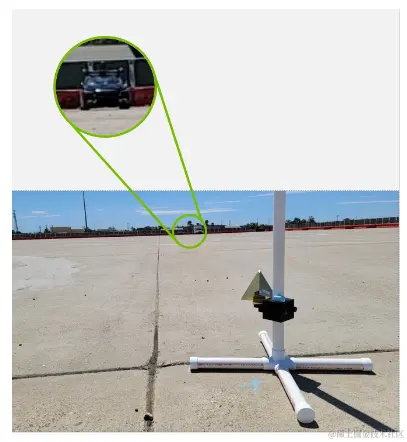 An image with a corner reflector in the foreground and a test vehicle at a far distance in the background./