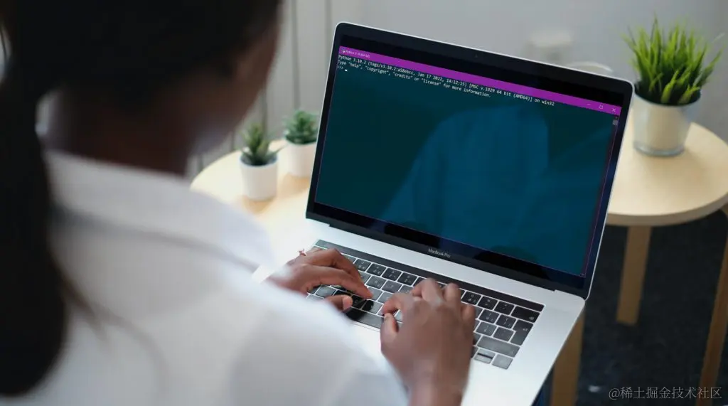 How to Master Python For Absolute Beginners in 6 Simple Steps. A lady typing in some Python code into a laptop.