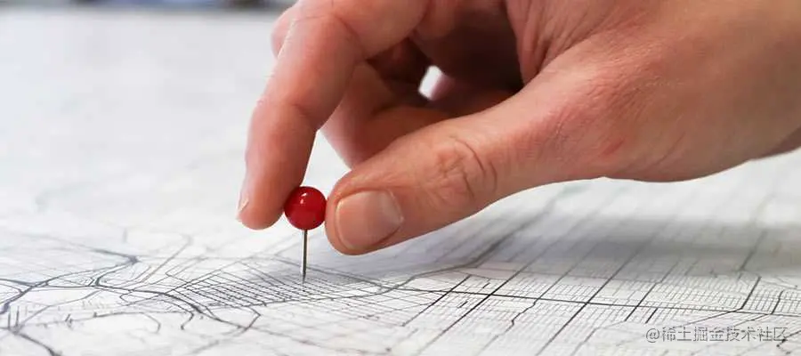 A person pushes a pin into a map.