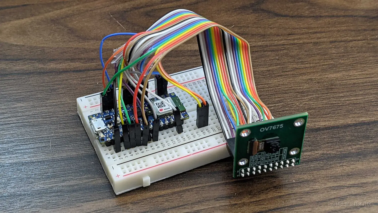 The Arduino Nano 33 BLE sense on a breadboard connected to the OV7675 camera through jumper wires