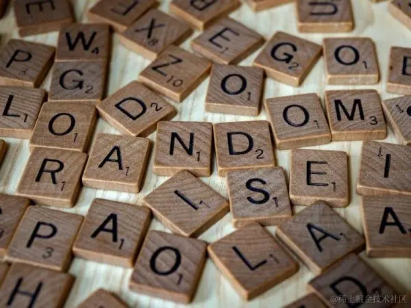 The image shows a pile of scrabble letters.
