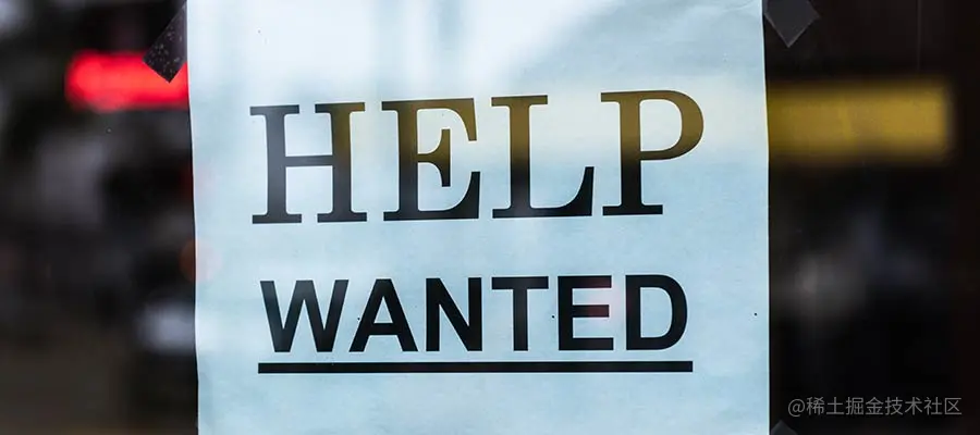 A "Help Wanted" sign in a window.